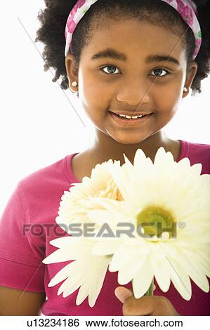 Stock Photograph - Girl holding large Gerbera Daisies . Fotosearch