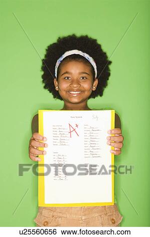Stock Photograph - Girl holding out graded school assignment. Fotosearch
