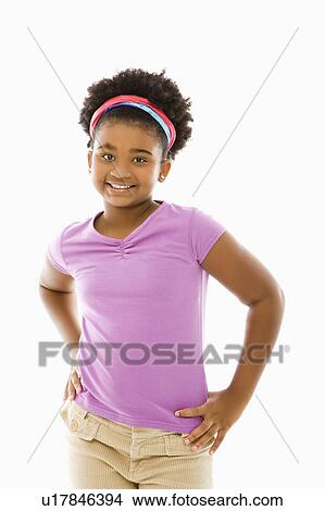 Picture - Girl with hands on hips smiling at viewer. Fotosearch