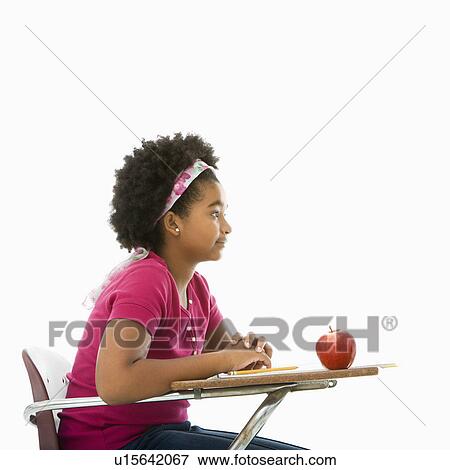 Side view of African American girl sitting in school desk. View Large Photo Image Stock Photo - Side view of African American girl sitting in school desk.. Fotosearch