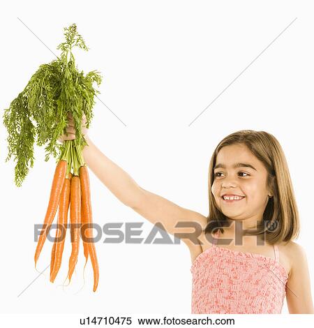 Smiling girl holding bunch of carrots View Large Photo Image Stock Photography - Smiling girl holding bunch of carrots . Fotosearch