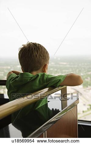 Young Caucasian boy leaning on railing at observation deck at Tower of the Americas in San Antonio, Texas. View Large Photo Image Picture - Young Caucasian boy leaning on railing at observation deck at Tower of the Americas in San Antonio, Texas.. Fotosearch