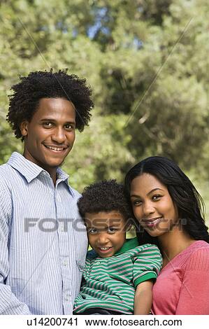 Family portrait of parents and young son smiling. View Large Photo Image Stock Image - Family portrait of parents and young son smiling.. Fotosearch