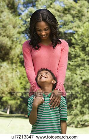 Mother and son looking at eachother smiling. View Large Photo Image Stock Photo - Mother and son looking at eachother smiling.. Fotosearch