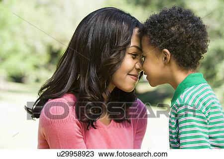Mother and young son with heads together smiling. View Large Photo Image Stock Image - Mother and young son with heads together smiling.. Fotosearch