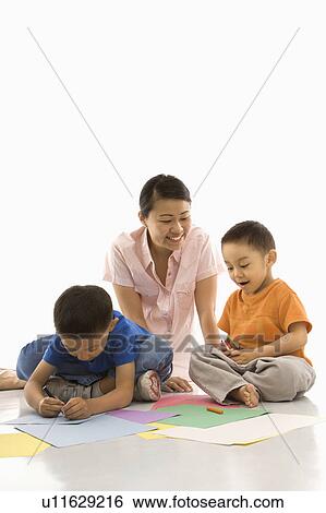 Mother with boys coloring View Large Photo Image Stock Photograph - Mother with boys coloring. Fotosearch