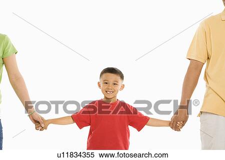 Stock Photography - Parents holding hands with son. Fotosearch