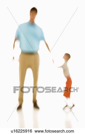Stock Photograph - Soft focus father holding son's hand.. Fotosearch