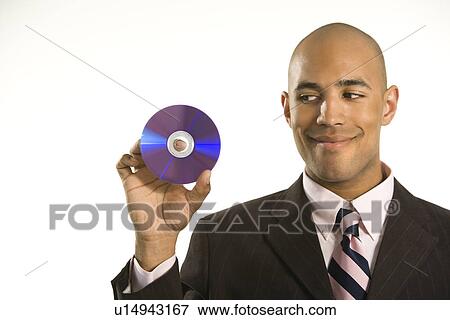 African American man smiling holding out compact disc. View Large Photo Image Stock Photo - African American man smiling holding out compact disc.. Fotosearch