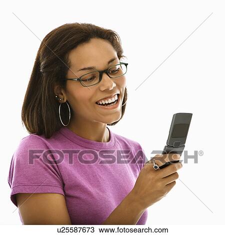 African American mid adult woman wearing glasses smiling at cell phone. View Large Photo Image Stock Image - African American mid adult woman wearing glasses smiling at cell phone.. Fotosearch