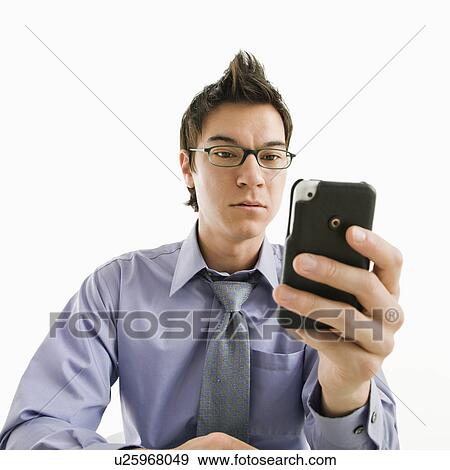 Stock Photo - Businessman with serious expression looking at his pda cellphone. Fotosearch