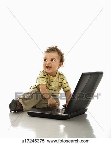 Happy African American toddler boy on laptop computer looking to side. View Large Photo Image Stock Photography - Happy African American toddler boy on laptop computer looking to side.. Fotosearch