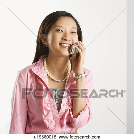 Portrait of Asian Chinese mid-adult female smiling and talking on cell phone. View Large Photo Image Stock Photo - Portrait of Asian Chinese mid-adult female smiling and talking on cell phone.. Fotosearch