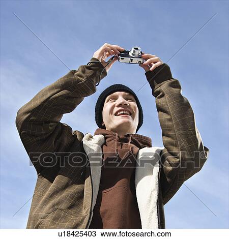 Teenager taking a picture View Large Photo Image Stock Image - Teenager taking a picture . Fotosearch