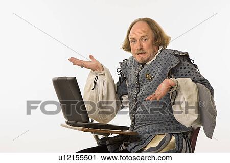 Stock Image - William Shakespeare sitting desk with laptop . Fotosearch
