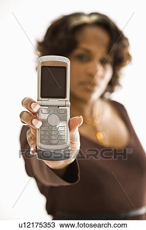 Stock Image - Woman holding out open cellphone.. Fotosearch
