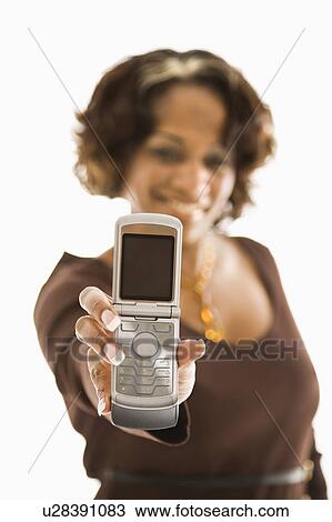 Stock Image - Woman holding out open cellphone.. Fotosearch