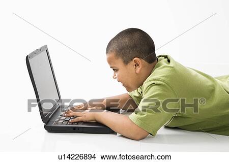 Young latino boy using laptop computer. View Large Photo Image Picture - Young latino boy using laptop computer.. Fotosearch