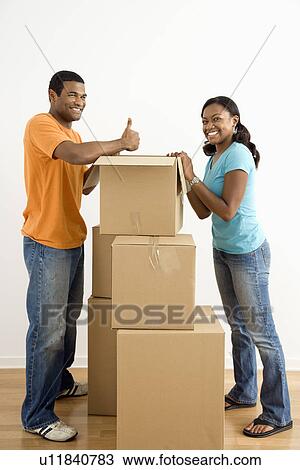 African American male and female couple packing cardboard boxes. View Large Photo Image Stock Image - African American male and female couple packing cardboard boxes.. Fotosearch