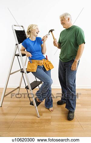 Couple with household tools next to ladder View Large Photo Image Stock Image - Couple with household tools next to ladder. Fotosearch
