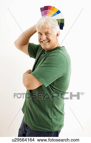 Man fanning paint swatches over his head View Large Photo Image Picture - Man fanning paint swatches over his head. Fotosearch
