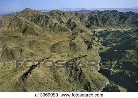 Stock Image - Aerial view of mountain range landscape.. Fotosearch