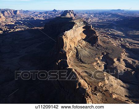 Stock Image - Aerial view of southwest desert with cliffs and rock formations.. Fotosearch