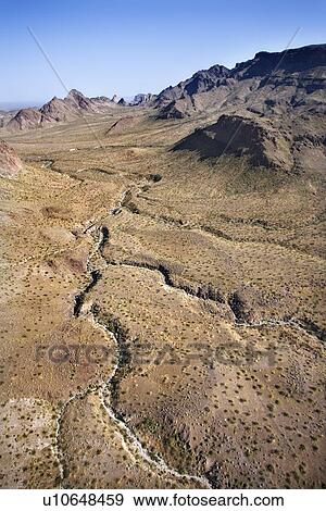 Stock Photo - Aerial view of southwestern landscape with mountains. Fotosearch