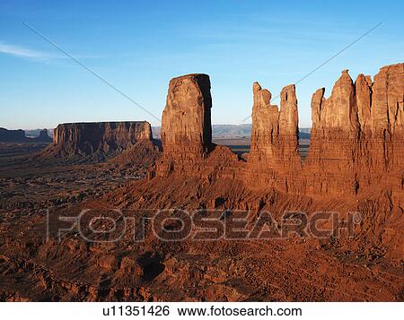 Sandstone mesas and buttes in desert of Monument Valley. View Large Photo Image Stock Photograph - Sandstone mesas and buttes in desert of Monument Valley.. Fotosearch