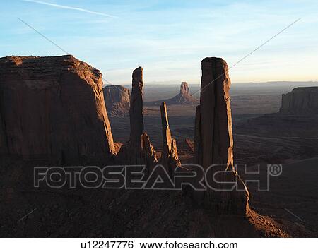 Stock Photograph - Three sisters rock formation in Monument Valley. Fotosearch