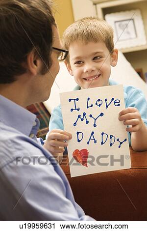 Boy giving father a drawing View Large Photo Image Stock Image - Boy giving father a drawing. Fotosearch