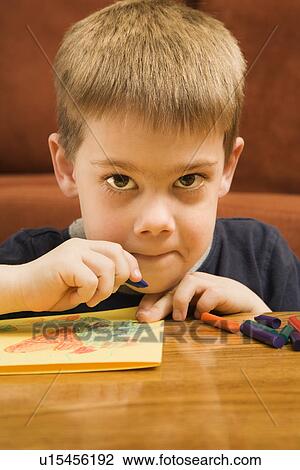 Caucasian boy drawing with crayons and looking at viewer. View Large Photo Image Stock Image - Caucasian boy drawing with crayons and looking at viewer.. Fotosearch