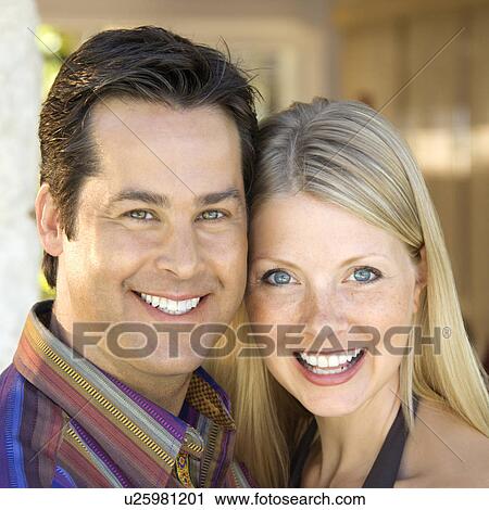 Stock Image - Caucasian mid adult couple smiling at viewer.. Fotosearch