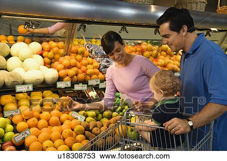 Caucasian mid-adult parents grocery shopping for fruit with male toddler. View Large Photo Image Stock Image - Caucasian mid-adult parents grocery shopping for fruit with male toddler.. Fotosearch