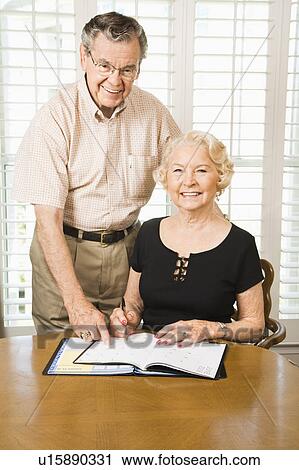 Stock Image - Couple looking at their calendar. Fotosearch