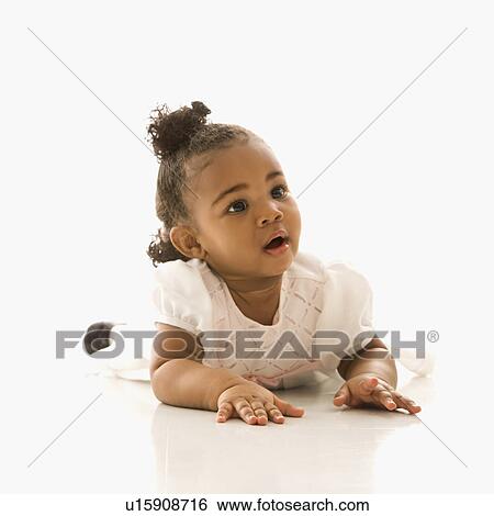 Stock Photograph - Portrait of African American infant girl against white background.. Fotosearch