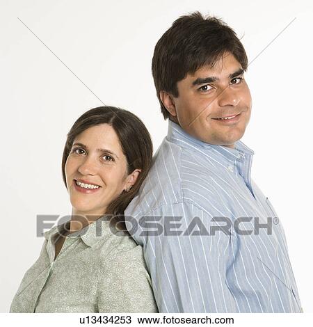 Portrait of couple standing smiling against white background. View Large Photo Image Stock Image - Portrait of couple standing smiling against white background.. Fotosearch