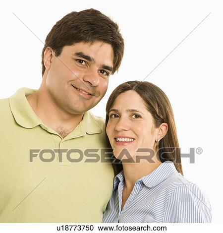 Stock Image - Portrait of smiling couple against white background. Fotosearch