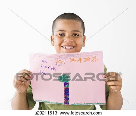 Young boy proudly showing drawing. View Large Photo Image Stock Image - Young boy proudly showing drawing.. Fotosearch