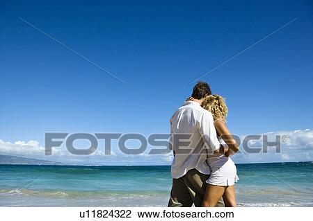 Attractive couple in embrace on Maui, Hawaii beach. View Large Photo Image Stock Image - Attractive couple in embrace on Maui, Hawaii beach.. Fotosearch