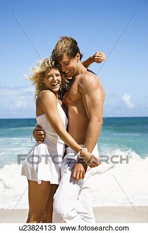 Couple embracing and smiling on Maui, Hawaii beach. View Large Photo Image Stock Image - Couple embracing and smiling on Maui, Hawaii beach.. Fotosearch
