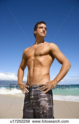 Handsome man standing on Maui, Hawaii beach. View Large Photo Image Stock Photo - Handsome man standing on Maui, Hawaii beach.. Fotosearch