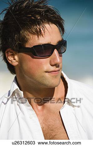 Head and shoulder portrait of attractive man wearing sunglasses on Maui, Hawaii beach. View Large Photo Image Stock Image - Head and shoulder portrait of attractive man wearing sunglasses on Maui, Hawaii beach.. Fotosearch