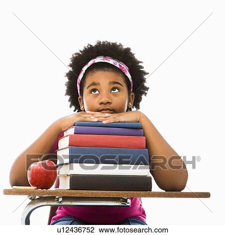 African American girl sitting in school desk with large stack of books looking bored. View Large Photo Image Stock Image - African American girl sitting in school desk with large stack of books looking bored.. Fotosearch