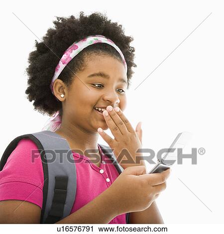 Girl with backpack talking on cell phone View Large Photo Image Stock Image - Girl with backpack talking on cell phone. Fotosearch