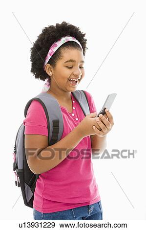 Stock Photo - Girl with backpack text messaging on cell phone. Fotosearch