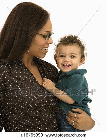 Stock Image - Mom holding toddler son with happy expression. Fotosearch