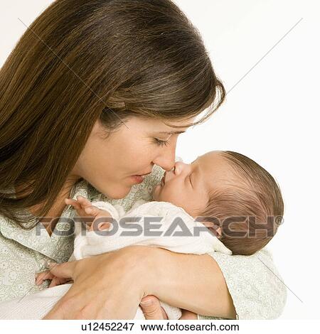 Mother nuzzling sleeping baby with nose and smiling View Large Photo Image Stock Photo - Mother nuzzling sleeping baby with nose and smiling. Fotosearch
