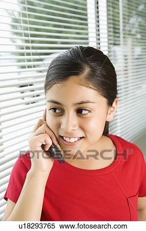 Stock Photography - Young girl talking on cell phone. Fotosearch