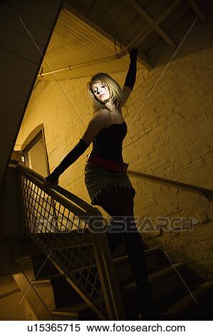 Caucasian female posing in stairwell with direct light on her face. View Large Photo Image Stock Photography - Caucasian female posing in stairwell with direct light on her face.. Fotosearch